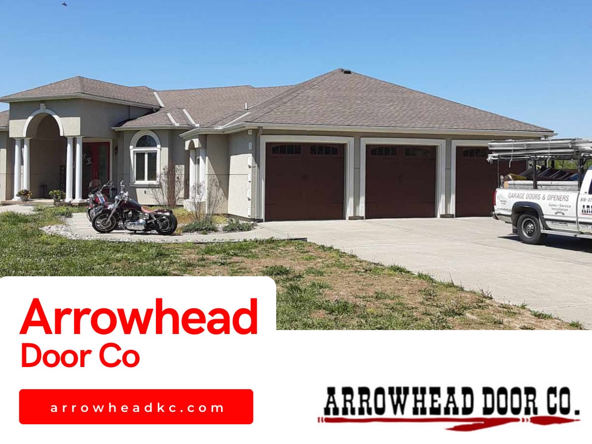 Arrowhead Door Co. service truck outside a home with three new brown carriage-style garage doors