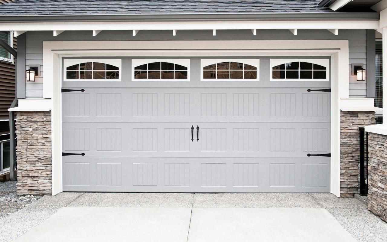 Garage door repair technician working on a residential garage door