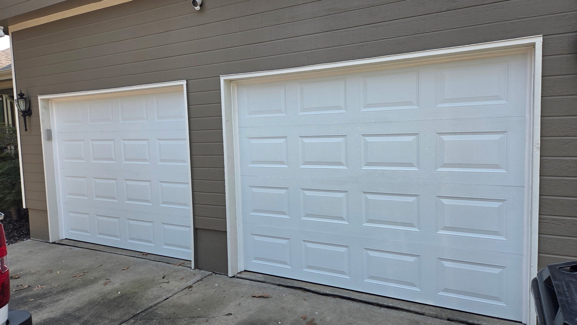 New white raised-panel garage doors