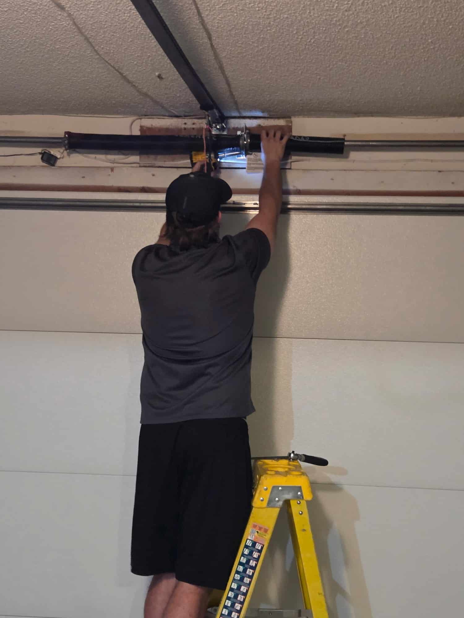 Arrowhead technician working above a garage door