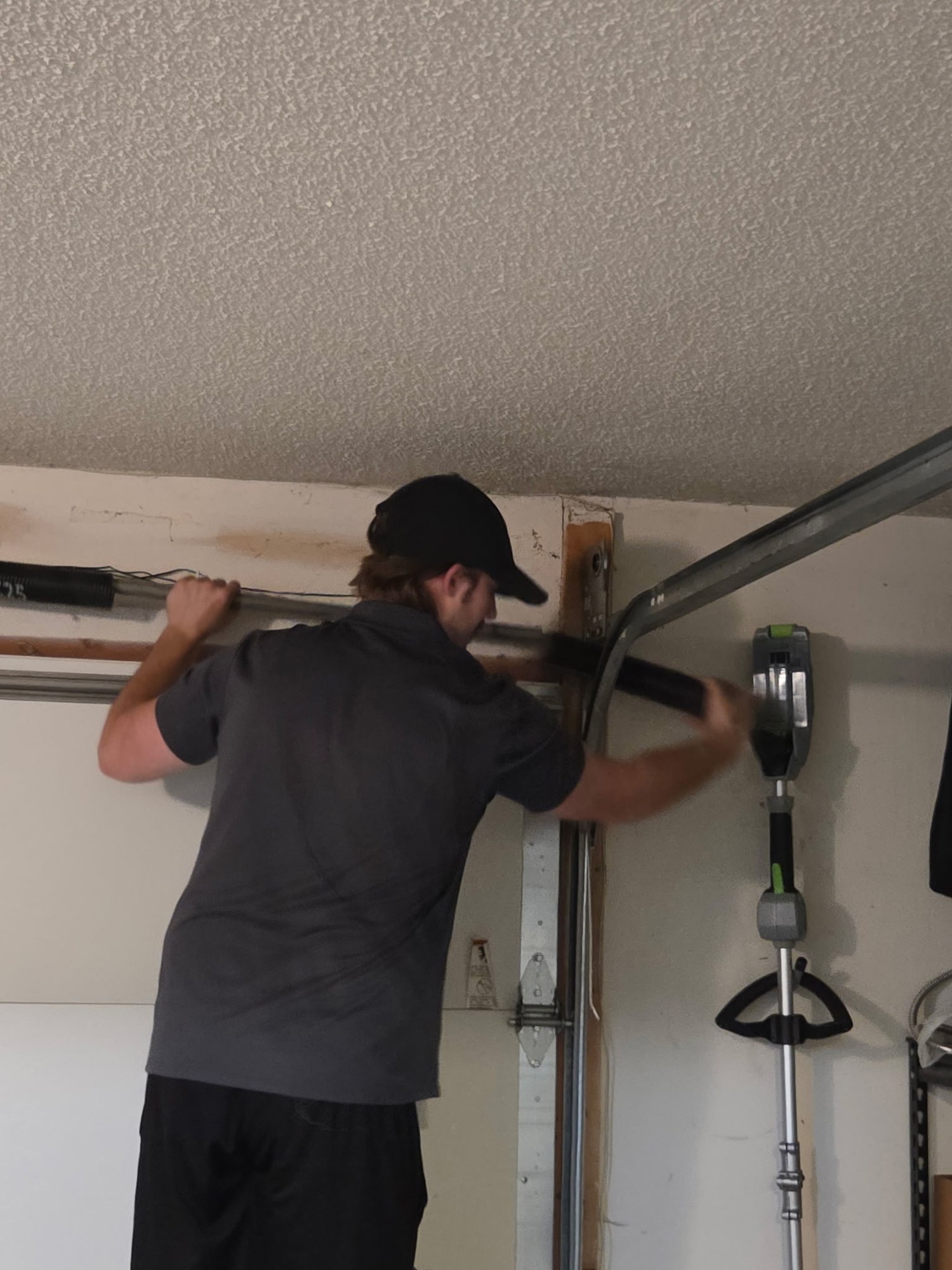 Technician tightening the torsion bar